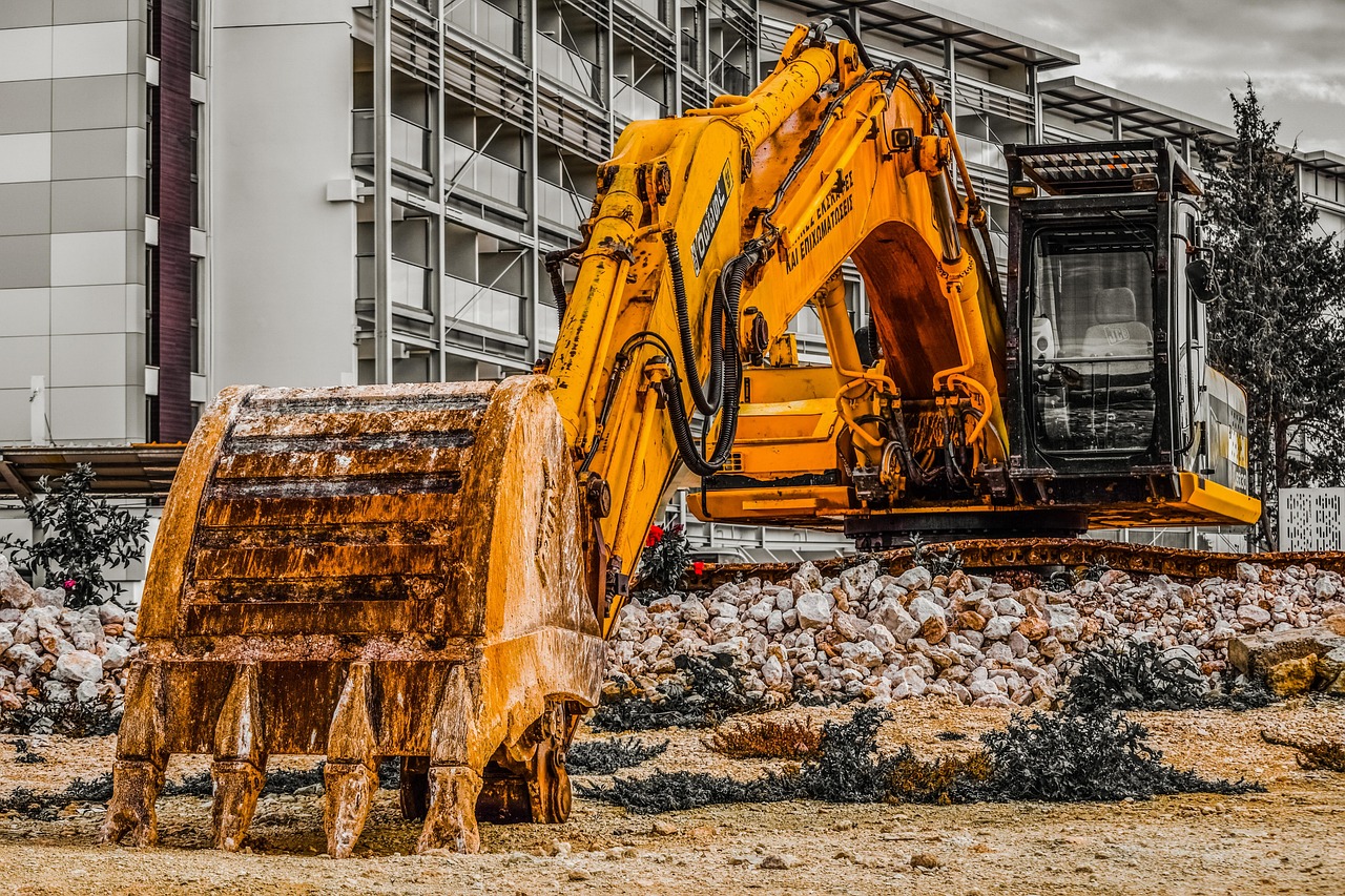 Excavator grading a Bentonville lot before construction